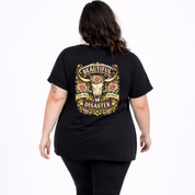 Person wearing a black t-shirt with a decorative design on the back, featuring text and graphics.