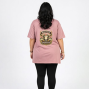 Person wearing a pink t-shirt with 'Beautiful Disaster' design on the back, standing against a white background.