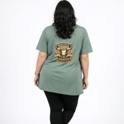 Person wearing a green t-shirt with 'Beautiful Disaster' design on the back