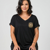 Woman wearing a black t-shirt with a logo on a gray background