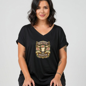 Woman wearing a black t-shirt with a graphic design on a plain background