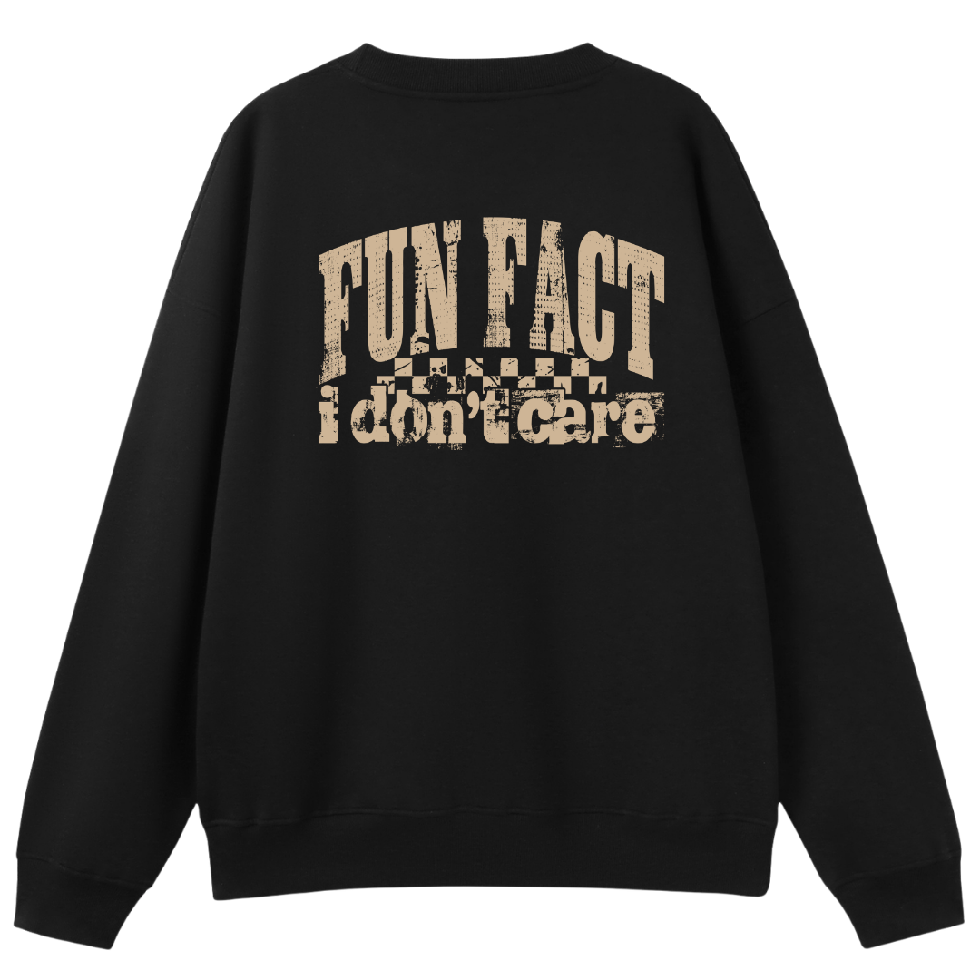 A black crewneck sweatshirt shown from the back, featuring a distressed beige graphic print that reads 'FUN FACT i don't care' with a small flag motif.