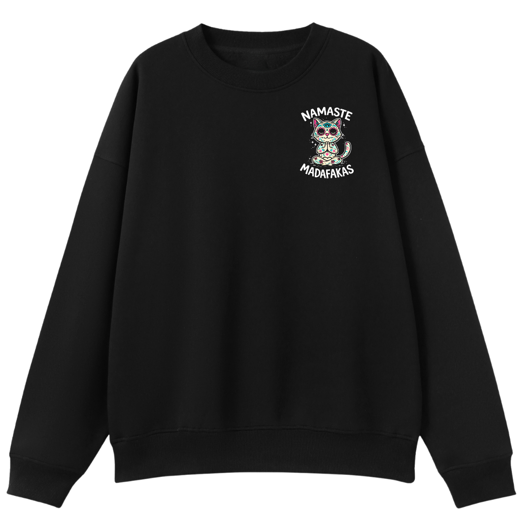 A black crewneck sweatshirt with a small graphic on the left chest featuring a cartoon owl and the text 'NAMASTE MADAMEFAKS' in white.