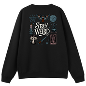 A black crewneck sweatshirt shown from the back, featuring a detailed graphic print with the words 'Stay Weird' in white, surrounded by occult and mystical illustrations including a pentagram, owl, dice, potion, tarot card, and mushrooms.