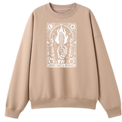 A beige crewneck sweatshirt featuring a white graphic print on the front with a hand holding a flaming torch and the text 'BURNS SAGE & BRIDGES'.
