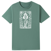A sage green short-sleeve crewneck t-shirt featuring a white tarot card graphic on the chest. The graphic depicts a burning candle held by a skeletal hand, with the text 'BURNS SAGE & BRIDGES' printed below.