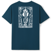 A dark teal blue short-sleeve t-shirt with a large white graphic print on the back. The graphic features a tarot card design with a hand holding a flaming torch, surrounded by a laurel wreath, stars, and moons, with the text 'BURNS SAGE & BRIDGES' at the bottom.