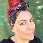 a colorful wire headwrap with a vibrant, abstract pattern. The headwrap is tied at the top, giving it a playful and chic bow effect.