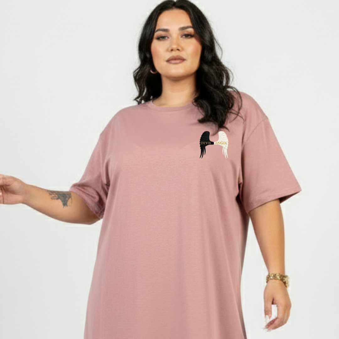 Woman wearing a mauve t-shirt with a graphic design on a plain background