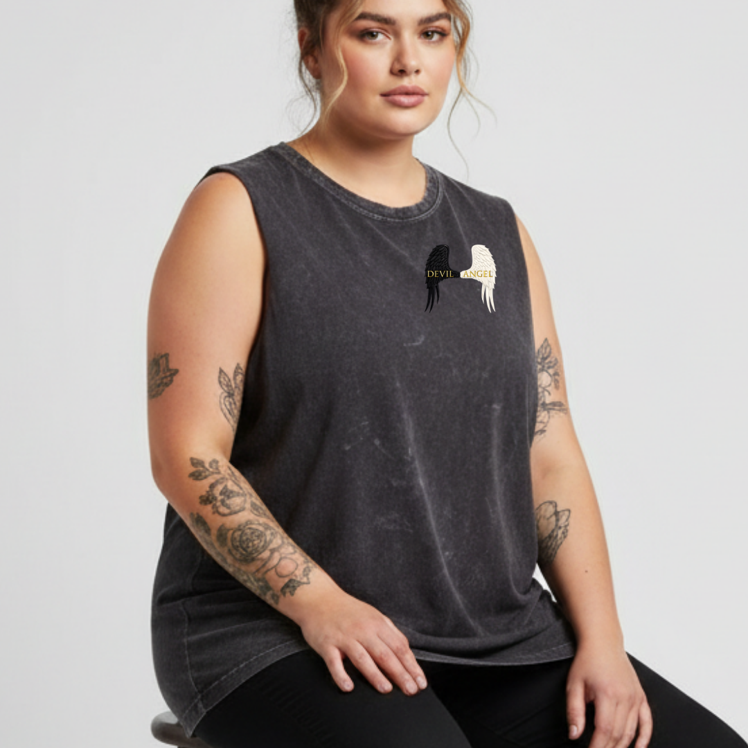 Woman wearing a dark gray sleeveless shirt with a graphic design on a light gray background