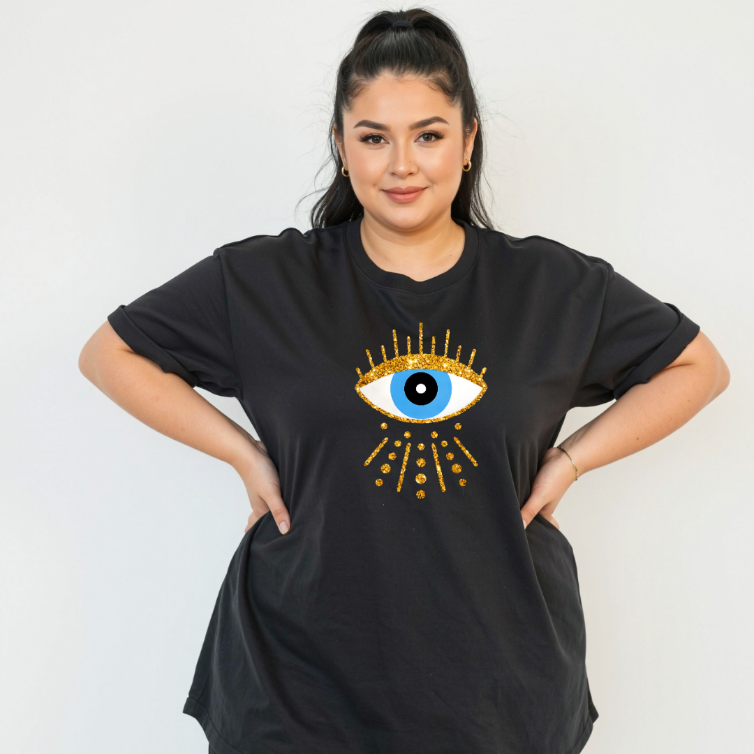 Woman wearing a black t-shirt with a decorative eye design on a plain background