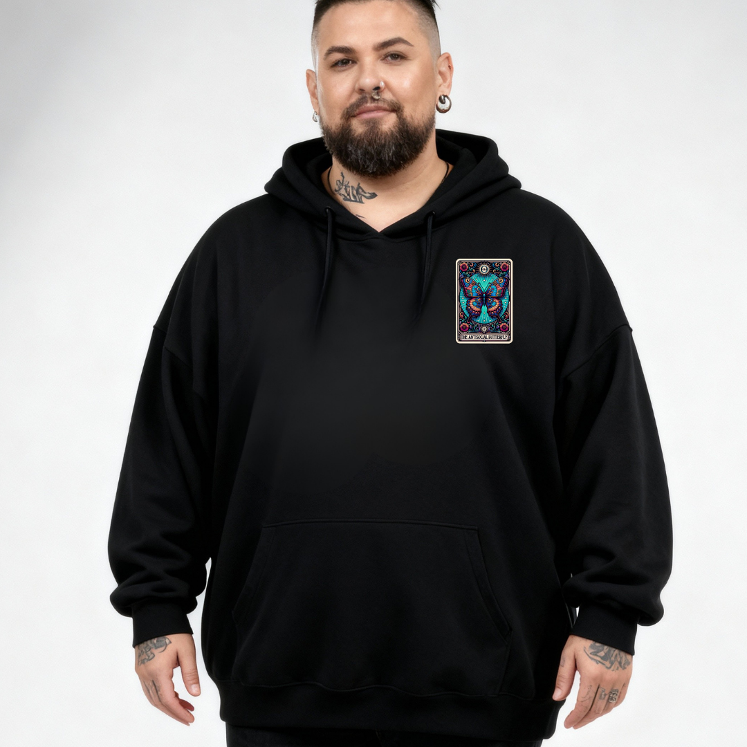 Man wearing a black hoodie with a colorful patch on a white background