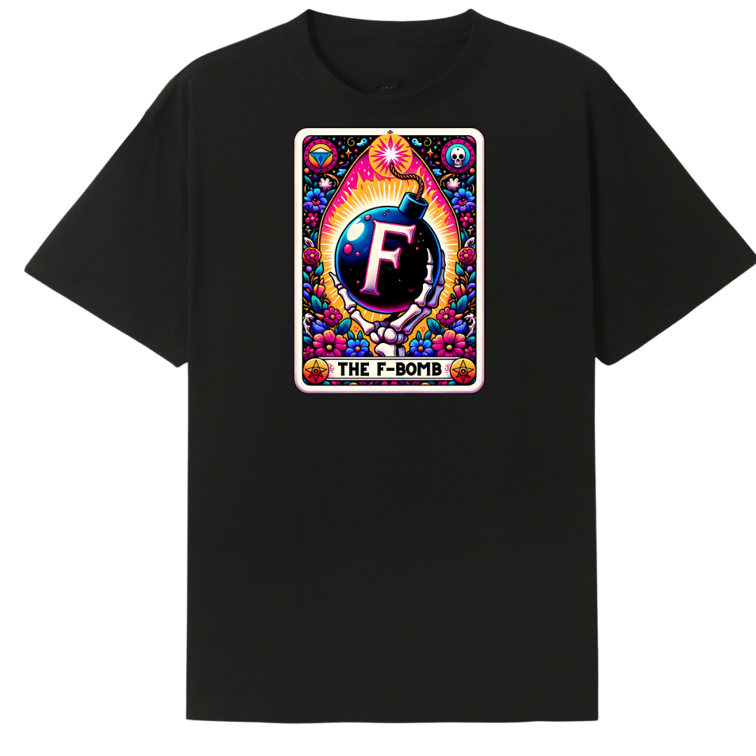 A black short-sleeve crewneck t-shirt featuring a colorful retro-style graphic print on the chest. The graphic is designed like a vintage card with the text 'THE F-BOMB' and a central emblem containing a stylized letter 'F'.
