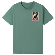 A sage green short-sleeve crewneck t-shirt with a colorful graphic on the left chest depicting a cosmic 'F' card design.