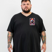 A man with a beard and tattoos wearing a black v-neck t-shirt with a colorful graphic print on the left chest. The graphic features a stylized letter 'F' inside a rainbow design with the text 'FUTURE FAN'.