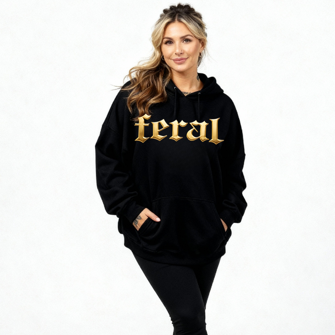 Woman wearing a black hoodie with 'feral' in gold letters on a white background