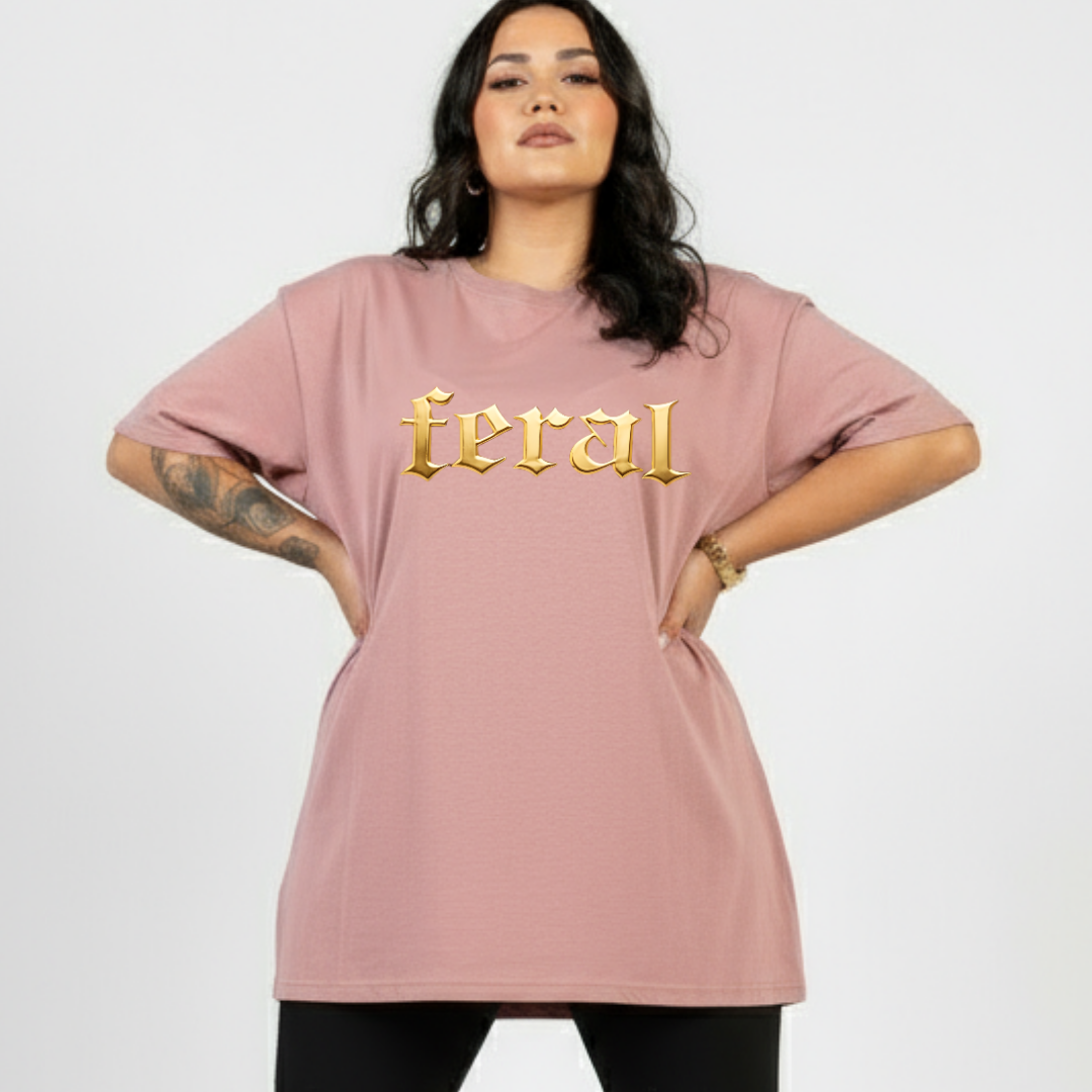 Woman wearing a pink t-shirt with 'feral' printed in gold on a white background