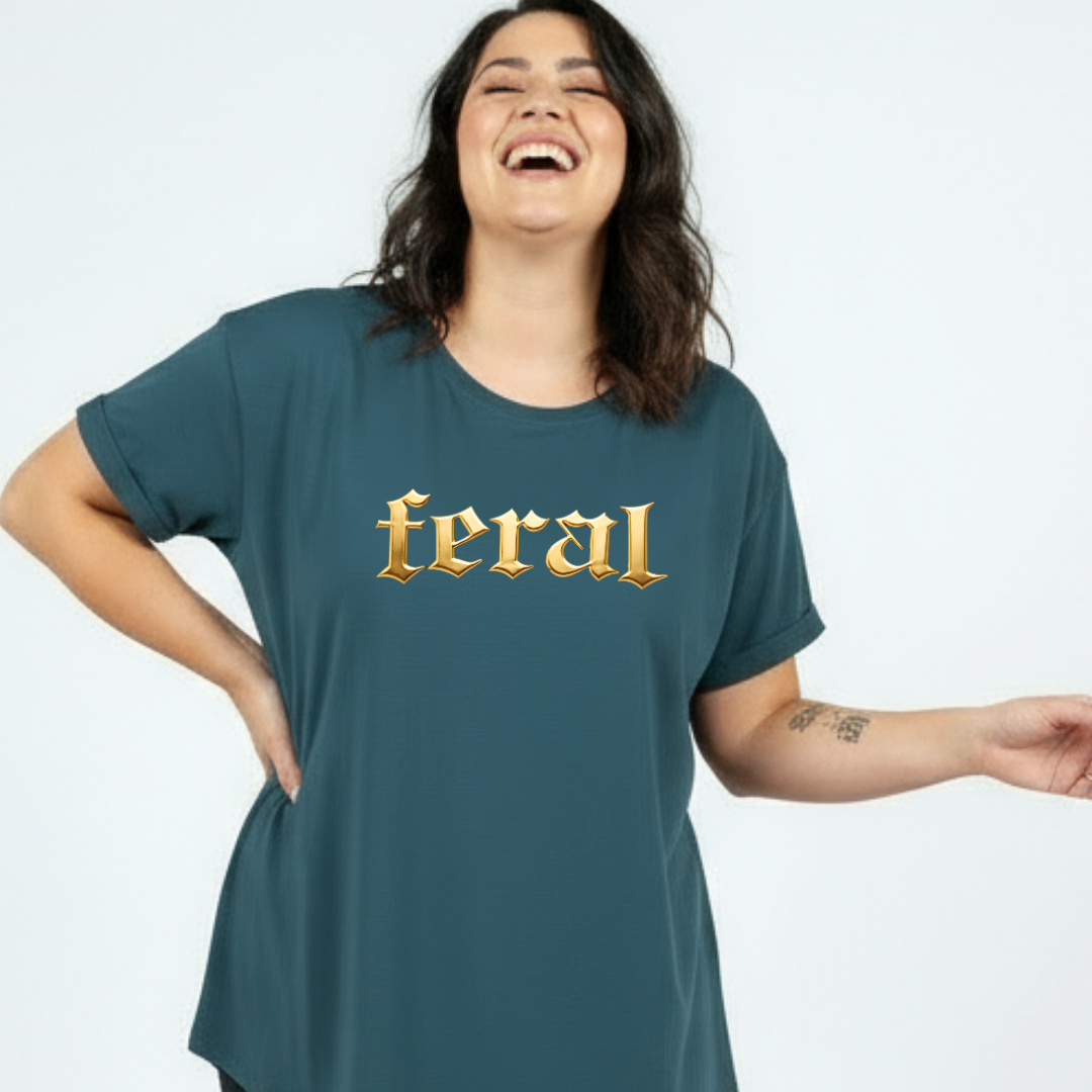 Woman wearing a teal t-shirt with 'feral' printed in gold on a white background