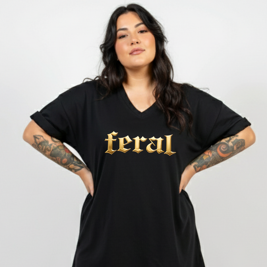 Person wearing a black t-shirt with 'feral' printed in gold on a plain background