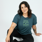 Woman wearing a teal t-shirt with festive design on a white background