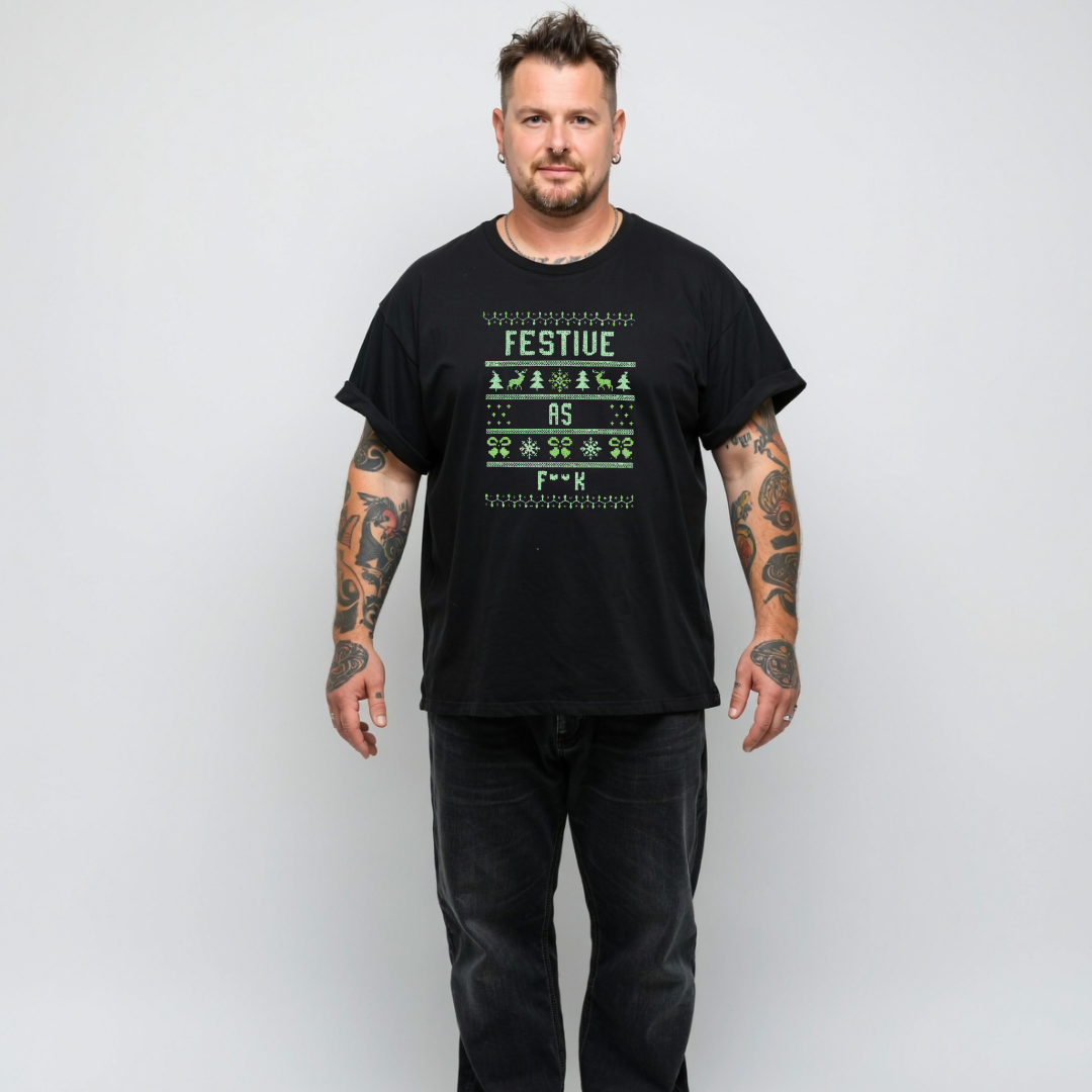 Man wearing a black t-shirt with festive design and text on a plain background