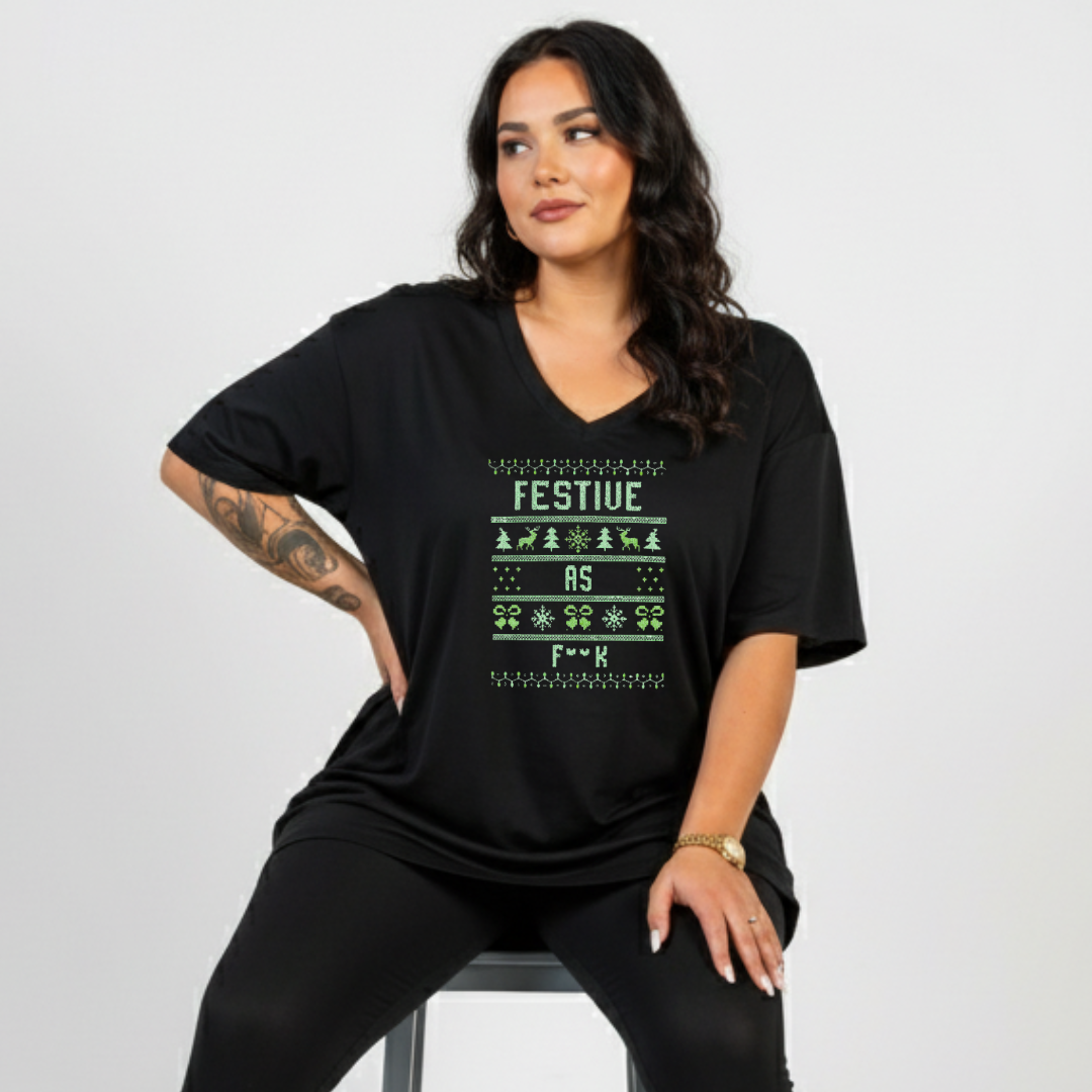 Woman wearing a black t-shirt with festive text design on a gray background