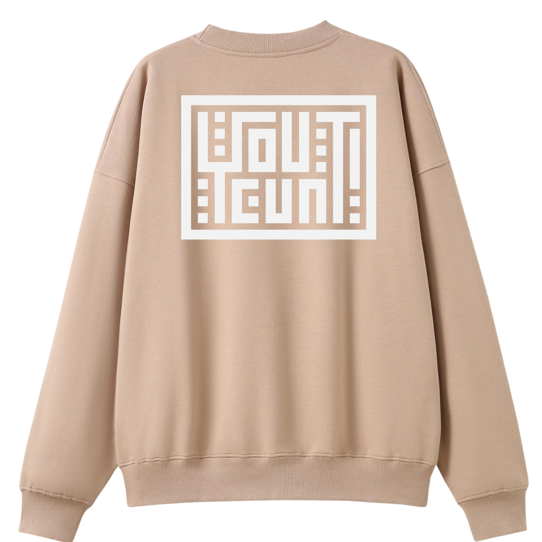 A beige crewneck sweatshirt shown from the back, featuring a large white graphic print with the word 'OUTSTANDING' in a geometric block design.