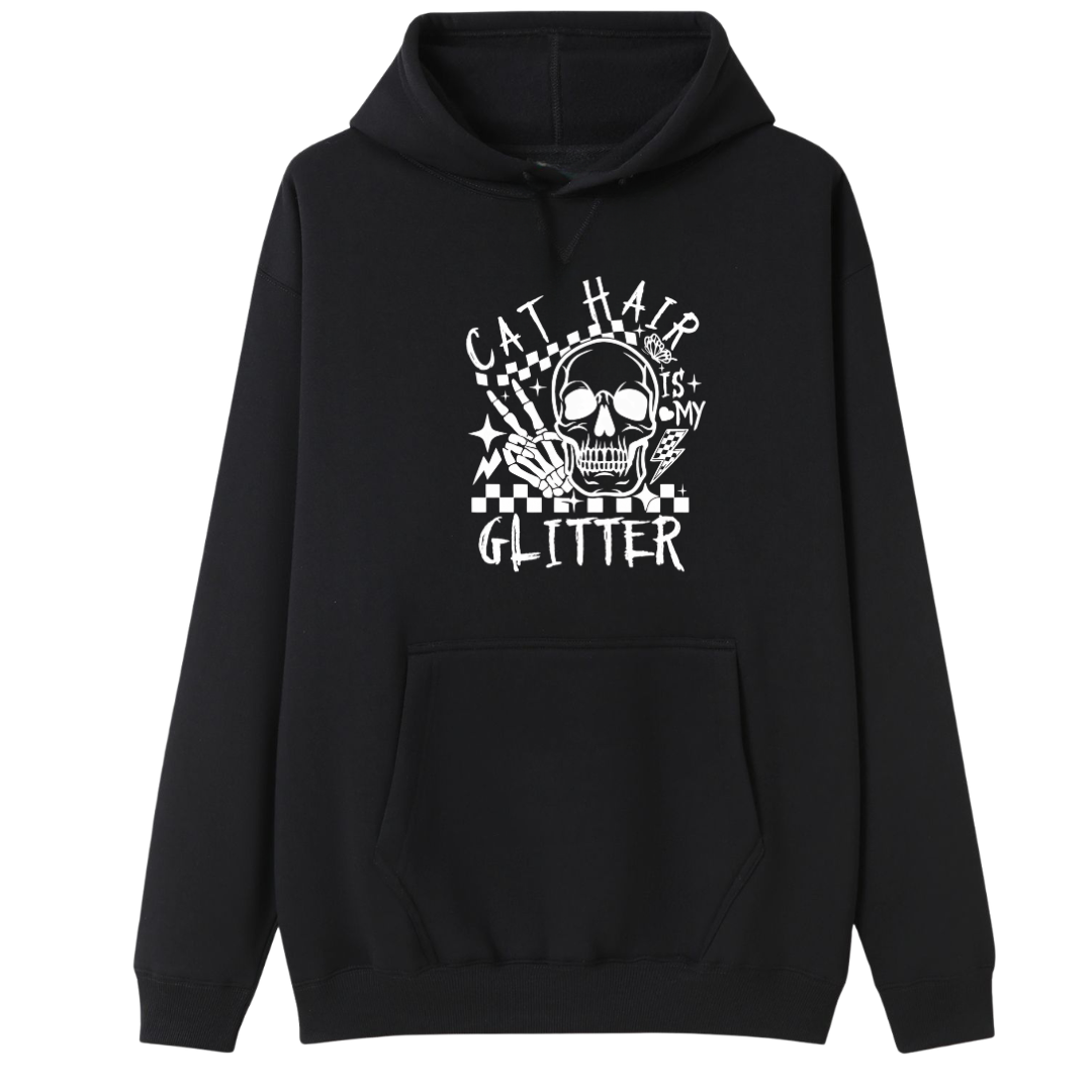 A black pullover hoodie with a white graphic print on the front featuring a skull, stars, and the text 'CAT HAIR IS MY GLITTER'.