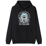 A black pullover hoodie with a front graphic of a skull with blue hair, surrounded by text and floral details, displayed on a solid white background.