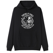 A black pullover hoodie with a front graphic of a skull with blue hair, surrounded by text and floral details, displayed on a solid white background.
