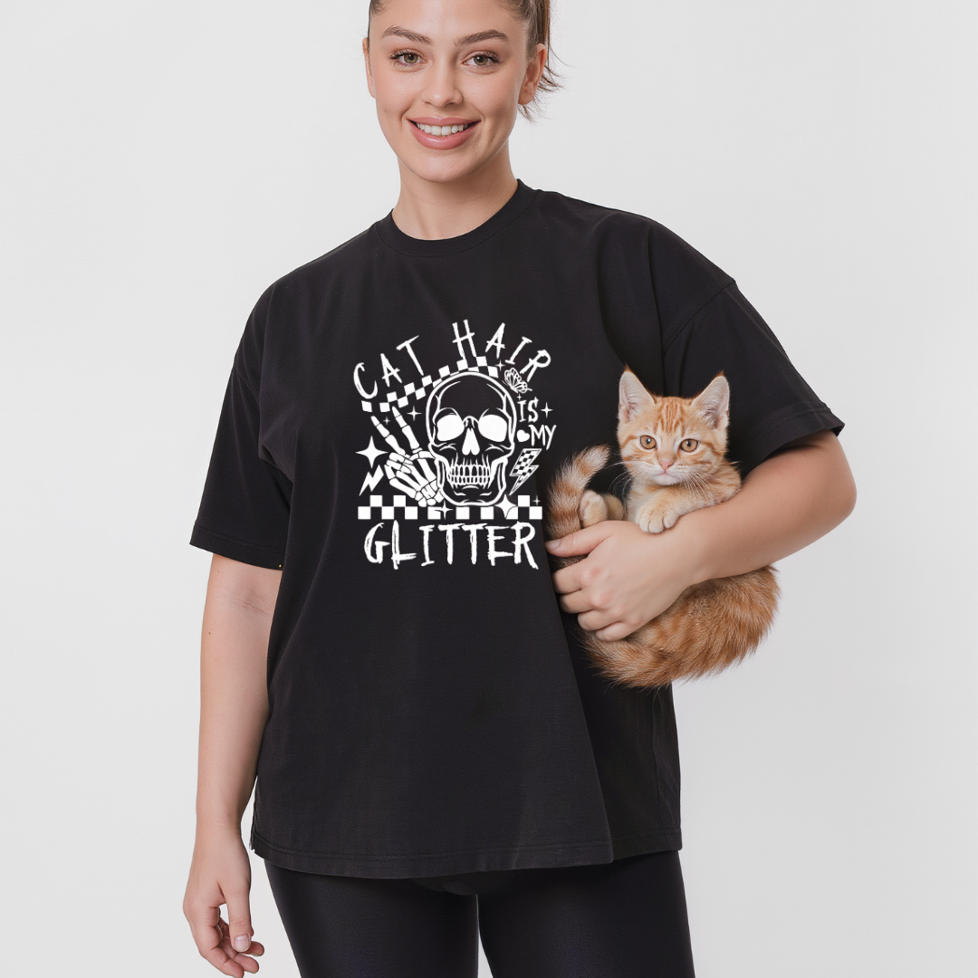 Person wearing a black t-shirt with a cat graphic and text, holding a cat.