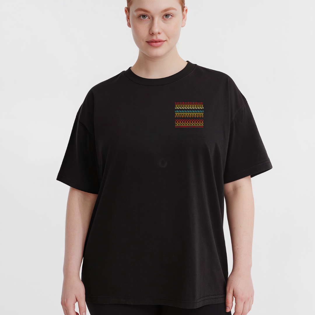 Person wearing a black t-shirt with a colorful graphic on the chest against a white background