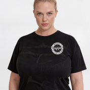 Person wearing a black t-shirt with a white logo on a white background