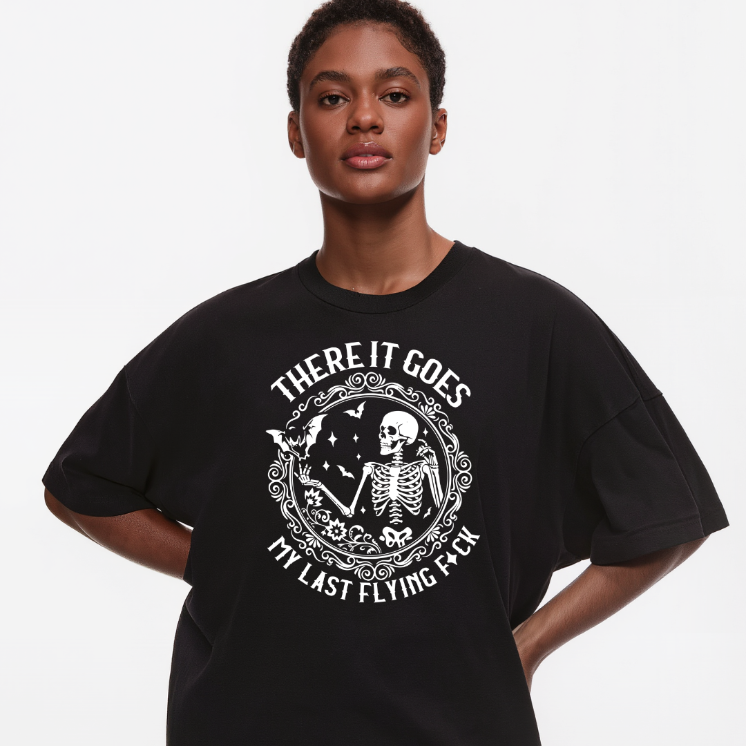 Person wearing a black t-shirt with a graphic design and text on a plain background
