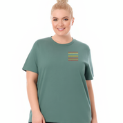 Woman wearing a green t-shirt with a small graphic on a white background