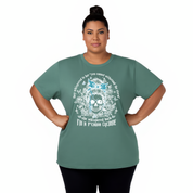 Woman wearing a green t-shirt with a skull design and text on a white background