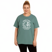 Person wearing a green t-shirt with a graphic design on a white background