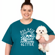 Person wearing a teal t-shirt with a graphic design holding a small white dog on a white background
