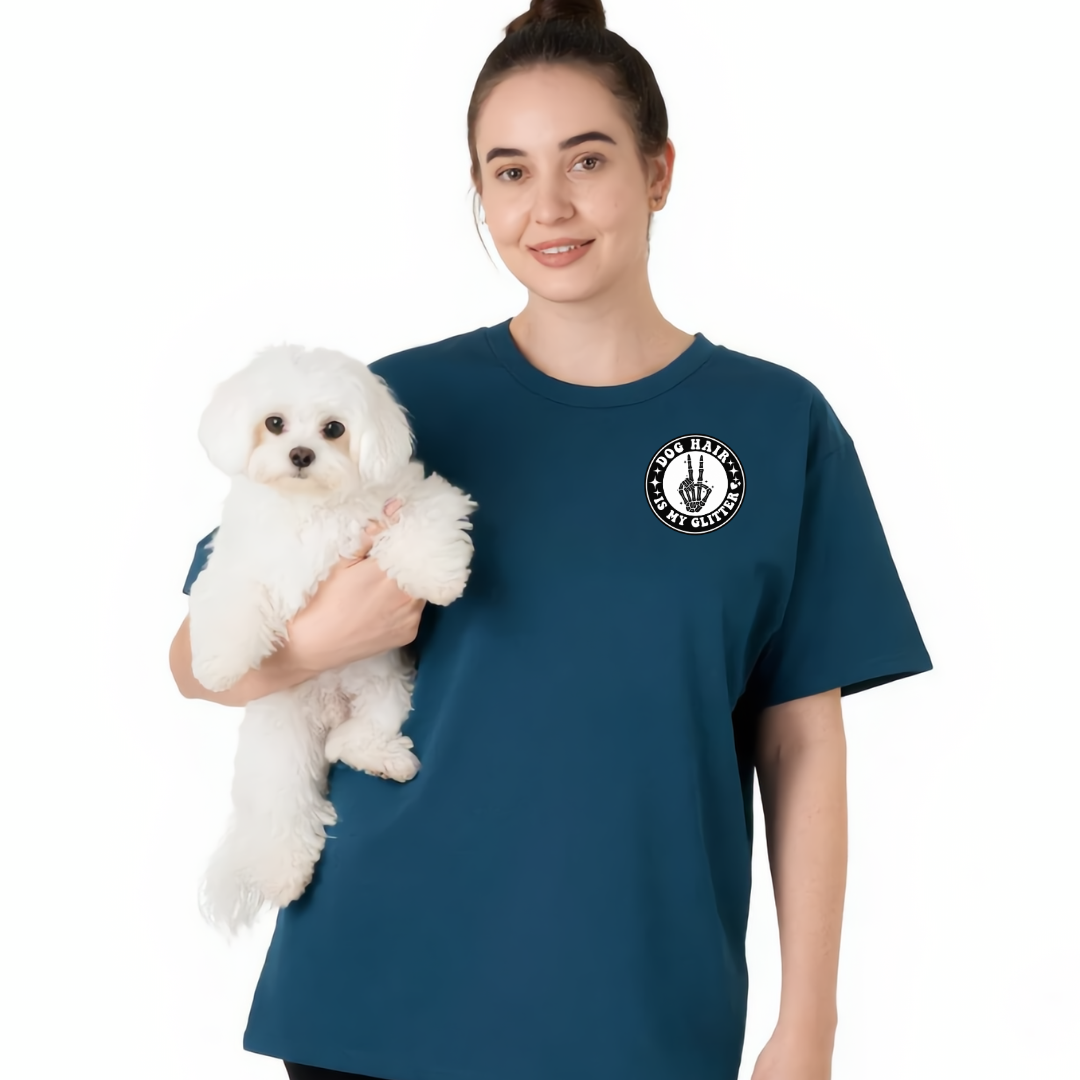 Woman holding a small white dog wearing a blue t-shirt with a logo on a white background