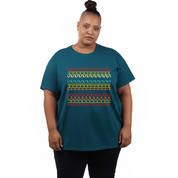 Person wearing a teal t-shirt with a colorful geometric pattern on a white background