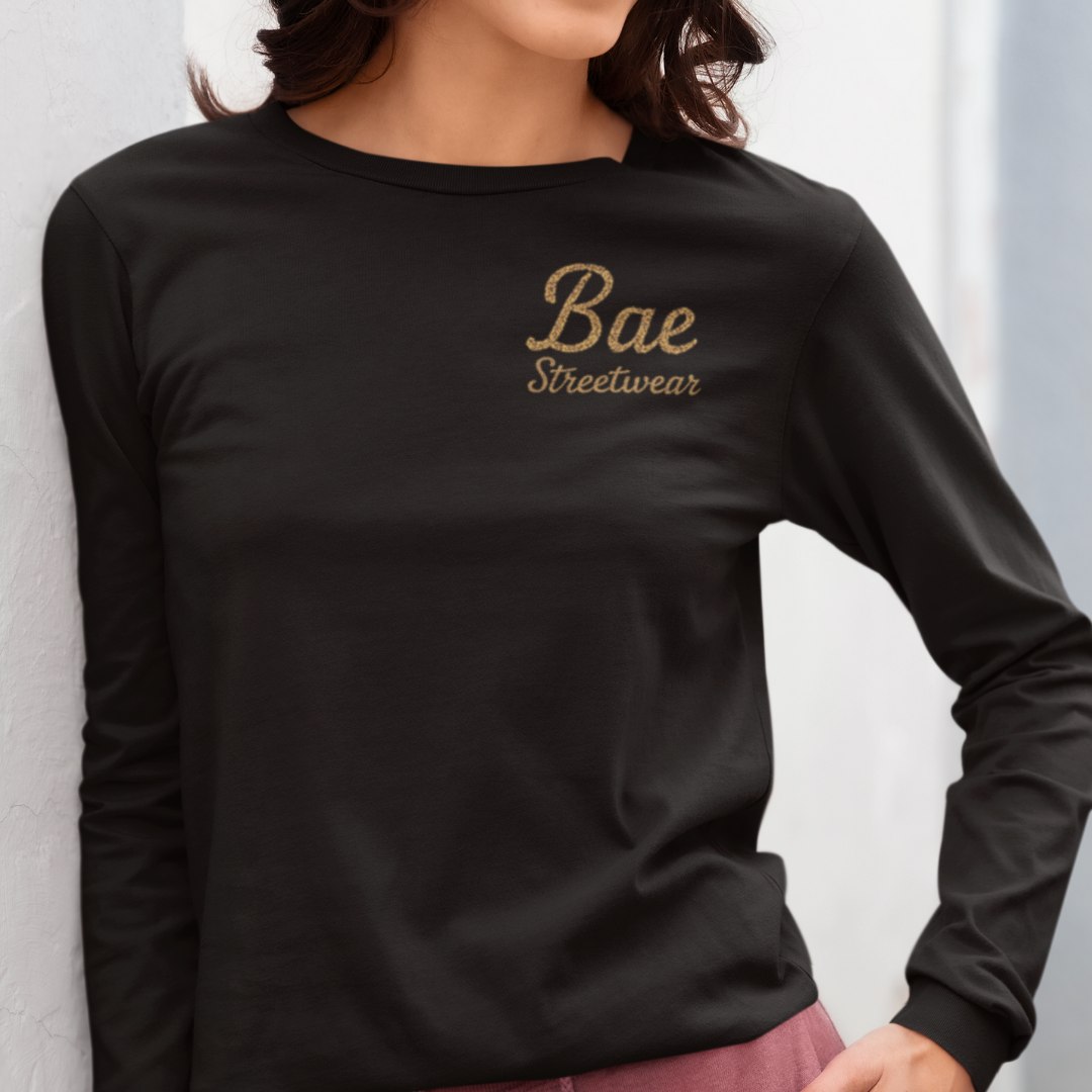 Unisex plus-size Fucks Given, Zilch long sleeve graphic tee in black featuring retro skull woman and cupcake illustration under bold slogan – handmade fearless streetwear