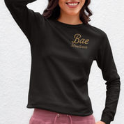 Unapologetic plus-size long sleeve graphic tee in black featuring ‘Own Your Wicked Side’ slogan and vintage skull woman with horns design – shop fearless Melbourne streetwear