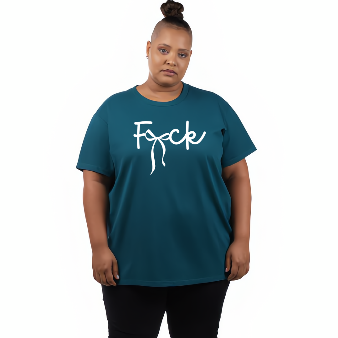 A plus-size model wearing a teal short-sleeve t-shirt with a white cursive graphic reading 'F*ck' across the chest, paired with black pants, against a plain white background.