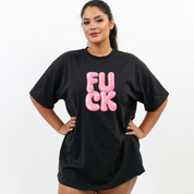Person wearing a black t-shirt with pink text on a white background