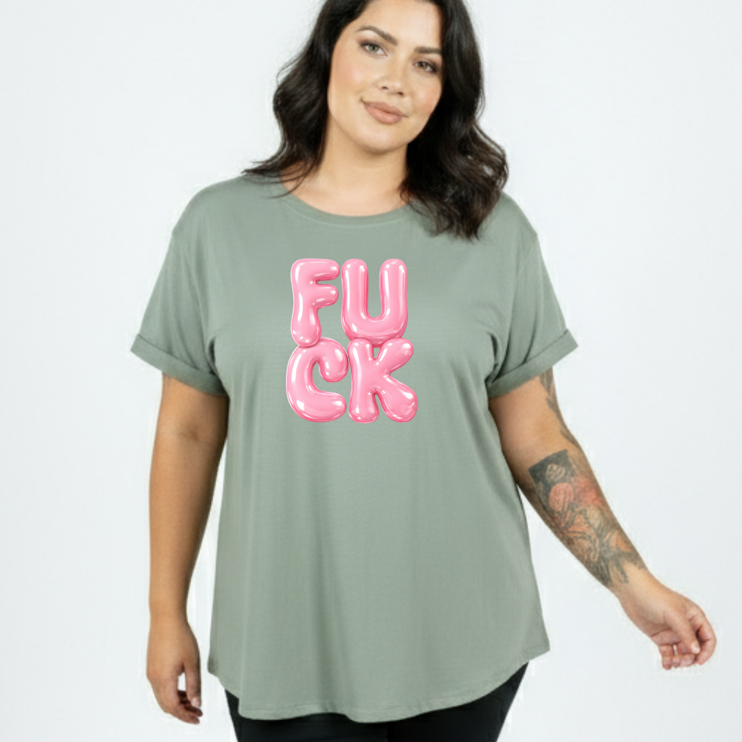 Person wearing a green t-shirt with pink text on a plain background