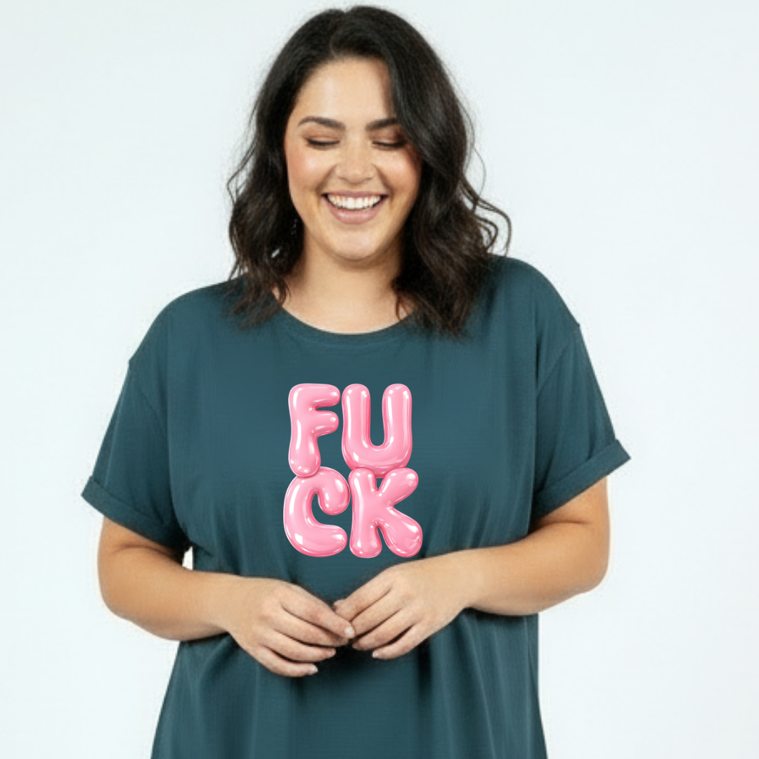 Woman wearing a teal t-shirt with pink text on a plain background