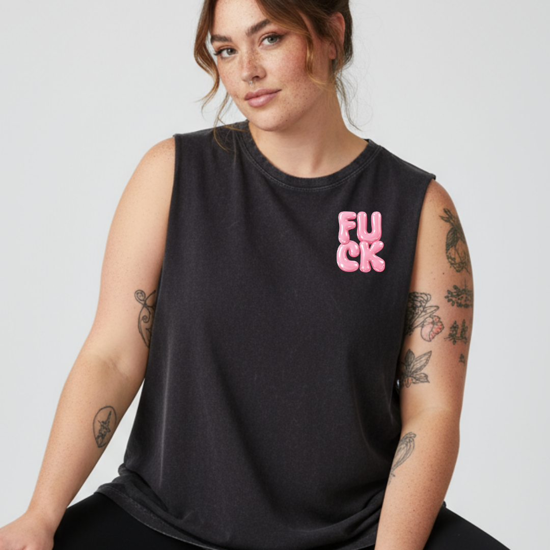 Person wearing a black sleeveless shirt with pink text on a plain background