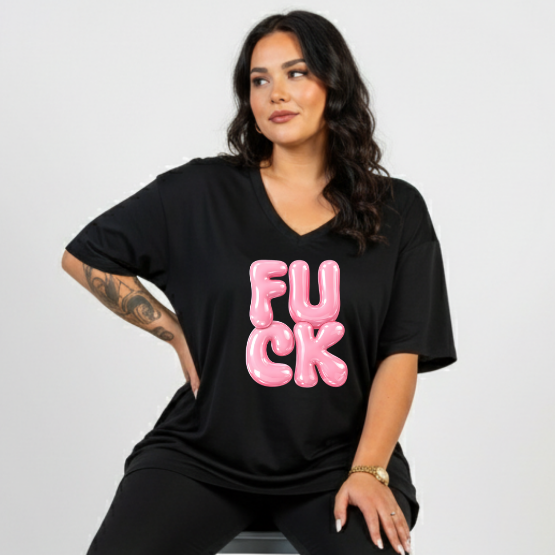 Woman wearing a black t-shirt with pink text on a plain background