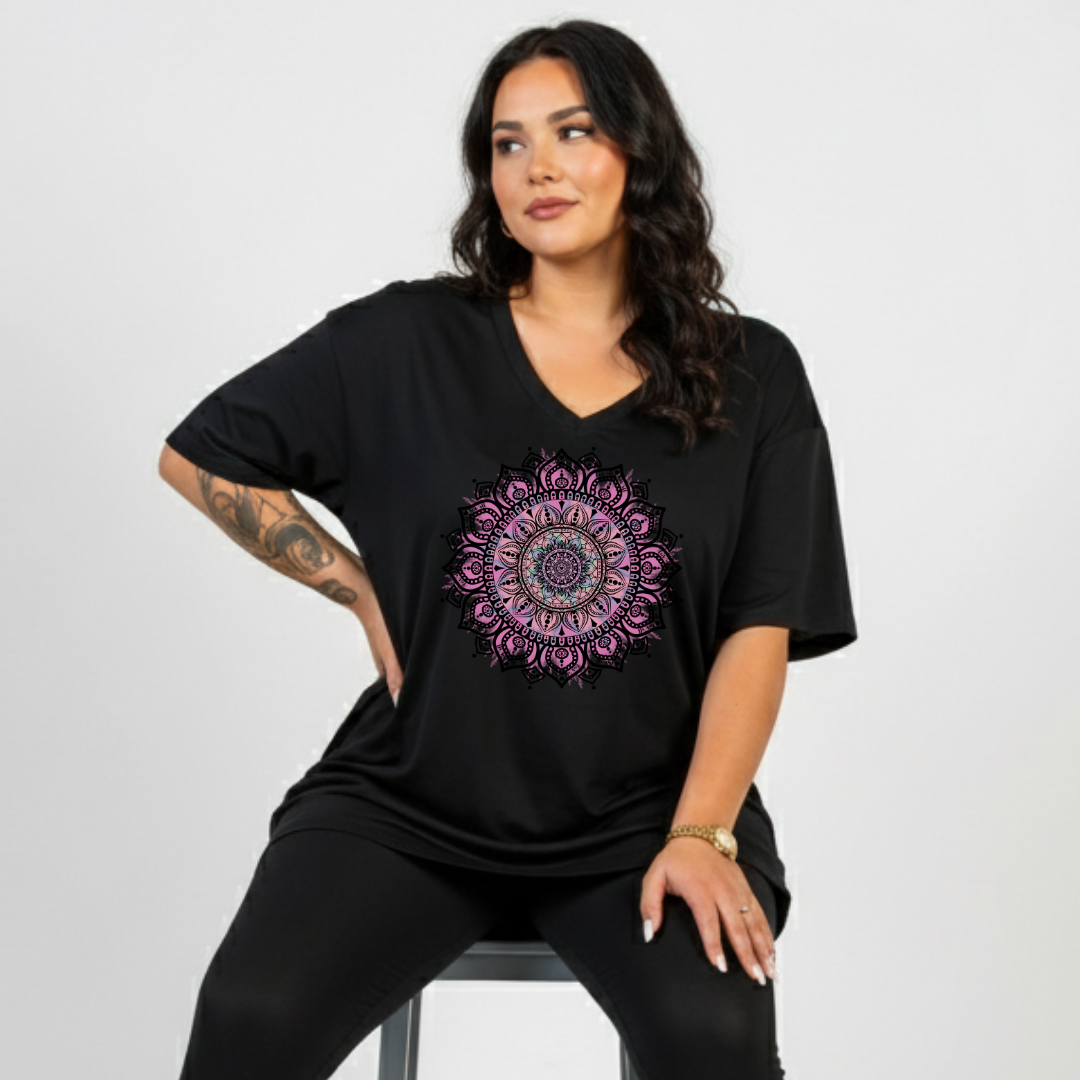 Woman wearing black v neck graphic tee with large intricate pink and teal mandala back print, plus size Australian streetwear by Bae Bands