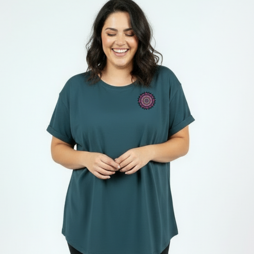 Woman wearing teal oversized graphic tee with large intricate pink and teal mandala back print, plus size Australian made streetwear by Bae Bands